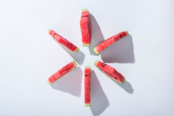 Wall Mural - Slices of ripe watermelon lie on a white background. Top view, flat lay