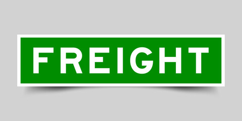 Wall Mural - Sticker label with word freight in green color on gray background