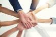 © Camerene P/peopleimages.com - Well conquer together. Closeup shot of a group of businesspeople joining their hands together in unity.