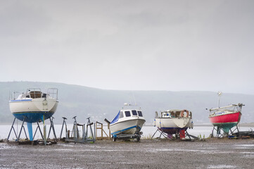 Boat moored out of water on support cradle