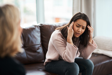 Canvas Print - I feel trapped inside my mind. Shot of a young woman having a therapeutic session with a psychologist.