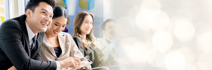 Cheerful young Asian businessman listen to the meeting intently Excited about the work that will be assigned. Happy Asian colleagues enjoying listening to business executives in office meetings