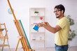© Elnur - Young man enjoying painting at home