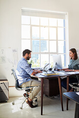 Canvas Print - Designers online. Shot of colleagues working on their computers at a desk in an open plan office.