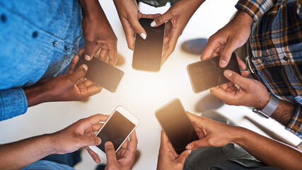 Poster - Closing in on the connection. Cropped shot of a group of people using their smart phones in synchronicity.
