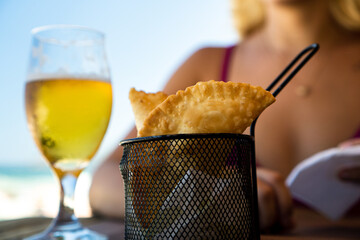 Brazilian snack Mini pasteis . Deep fried pastry. Traditonal food pastel. Selective focus