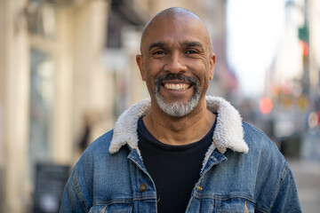 Wall Mural - Mature black man in city smile happy face portrait