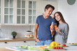 © BestForYou - Portrait of young couple in the kitchen with carrot juice. Healthy eating