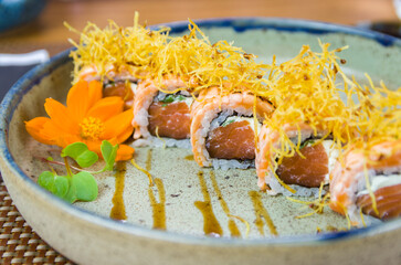 Platter decorated with different flavors of elegant uramaki sushi.