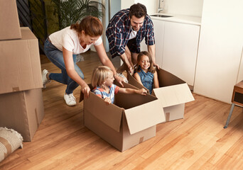 Canvas Print - Playing around while unpacking. Shot of a young family on their moving day.