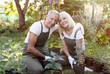 © Prostock-studio - Portrait of senior couple gardeners embracing each other and smiling, sitting in backyard and transplanting flowers