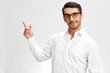 © SHOTPRIME STUDIO - handsome man white shirt posing holding thumbs up spectacled light background