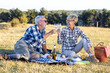 © pucko_ns - Mature couple in nature drinking wine, eating food and having fun at nature