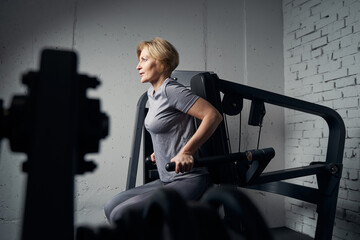 Sporty woman having workout in fitness center