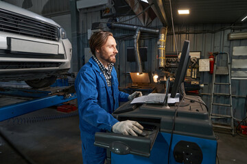 Wall Mural - Portrait of man working at computer in service center