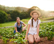 © Nikish H/peopleimages.com - Mommys teaching me how to run this farm. Portrait of a young girl working on the family farm with her mother in the background.