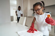 © Svitlana - Young girl carefully wiping the table in gloves