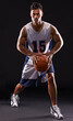 © Duncan M/peopleimages.com - Going for three. Studio shot of a basketball player against a black background.