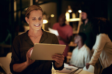 Poster - I have everything saved on here for my meeting tomorrow. Shot of a businesswoman using a digital tablet in an office at night.