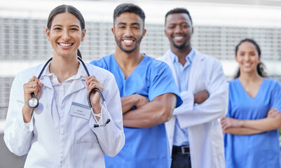 Poster - Were here to take care of you. Shot of a group of doctors standing against a city background.