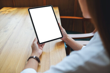 Mockup image of a woman holding digital tablet with blank white desktop screen