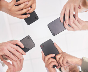Poster - We need to know the group gossip. Shot of a group of coworkers together using their smartphones.