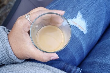 Wall Mural - Woman drinking hot coffee on hand