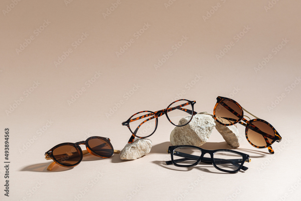 Sunglasses and glasses sale concept. Trendy sunglasses on beige background. Trendy Fashion summer accessories. Copy space. Summer sale. Optic store discount poster. Minimalism