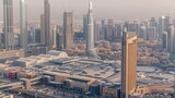 Fototapeta Miasto - Aerial view of tallest towers in Dubai Downtown skyline and highway timelapse.