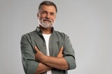 Portrait of smiling mature man standing on white background
