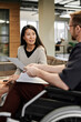 © Westend61 - Businesswoman talking to disabled colleague in office