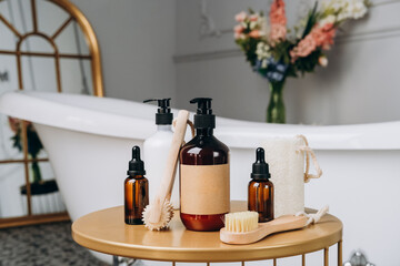 Wall Mural - Body and face care beauty bath set. shampoo shower gel  Lotion, cream, massage brushes and anti-cellulite in a basket on the table near the bathtub in the bathroom 