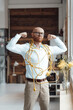 © Westend61 - Confident young businessman covered with cable flexing muscles in office