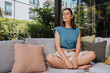 © Westend61 - Woman with brain wave frequency wearable on her head relaxing in garden, Cologne, NRW, Germany