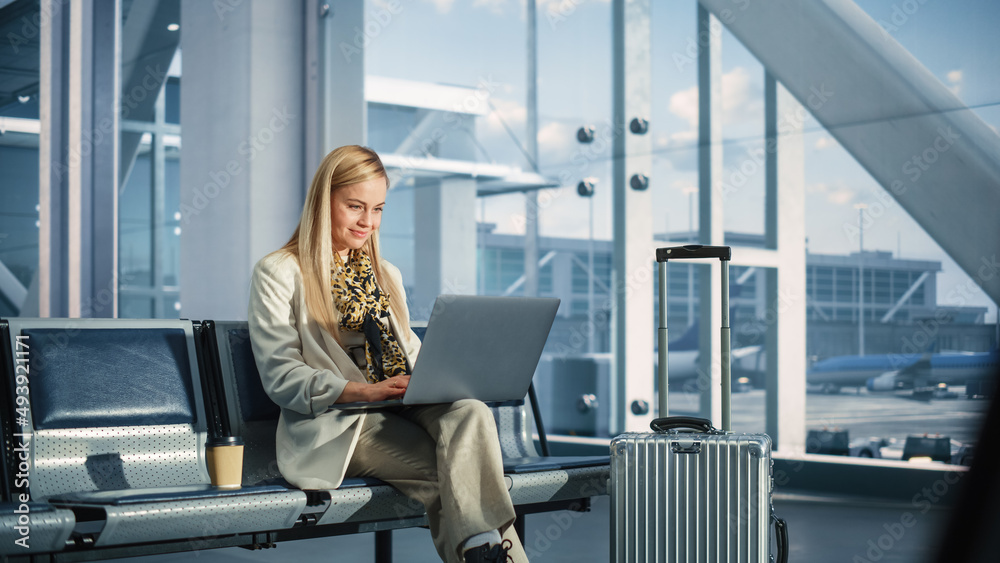 Airport Terminal: Smiling Woman Waits for Flight, Uses Laptop, Browse ...