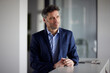 © Westend61 - Contemplative businessman standing at desk in office