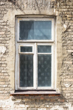 Old Ruined Building Window. Brick Wall Apartment Building Background. Post War Architecture. Broken Old Wooden Window Frame. Historic Tenement House Background.