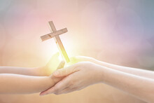 Baby Hand And Mom Hand Holding Light-emitting Cross Asking For Blessings From God