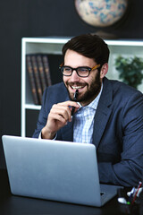 Sticker - Ive got just the idea.... Cropped shot of a young businessman sitting in front of a laptop and thinking in a modern office.