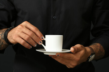 Wall Mural - Male hands with trendy manicure holding cup of coffee, closeup