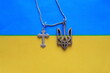 Ukrainians are Christians. They kneel only before God. Therefore, the pectoral cross hangs next to the symbol of freedom
