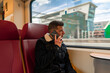 © TxemaPhoto - Man talking on the phone. traveling by train