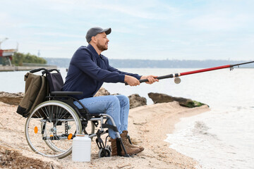 Canvas Print - Man in wheelchair fishing on river