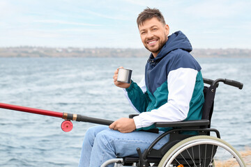 Poster - Man in wheelchair drinking tea while fishing on river