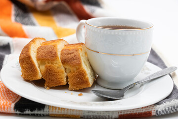 Wall Mural - slices of freshly baked pound cake with tea over on white background