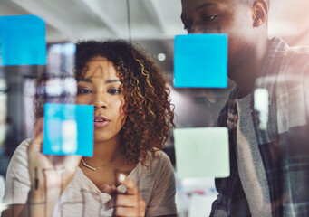 Aufkleber - Focused on the plan. Cropped shot of two young designers planning on a glass board.