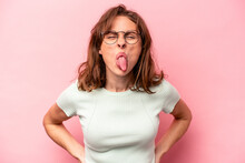 Young Caucasian Woman Isolated On Pink Background Funny And Friendly Sticking Out Tongue.
