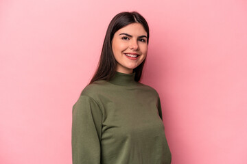 Wall Mural - Young caucasian woman isolated on pink background confident keeping hands on hips.