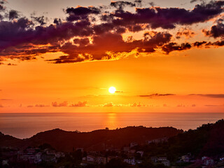 breathtaking view of the bright sun shining on the clear ocean water during a golden sunset