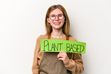 Young gardener woman holding a plan based placard isolated on white background happy, smiling and cheerful.